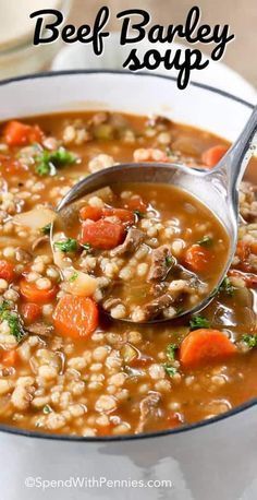 a bowl of beef barley soup with a spoon in it