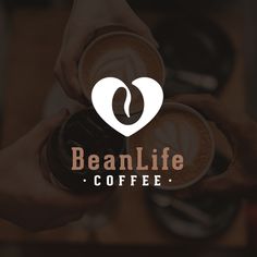 two hands holding coffee cups with the words beanlife coffee on it and a heart in the middle