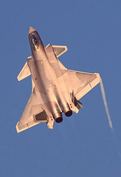 a silver fighter jet flying through a blue sky