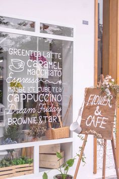 there is a sign in the window that says coffee and cafe