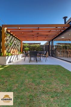 an outdoor covered patio with table and chairs under a pergolated awning over the dining area