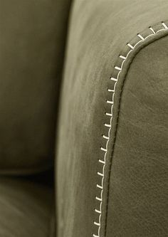 a close up view of the back end of a couch with stitching on it