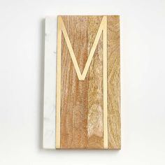 a wood and marble block with the letter m on it