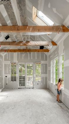 a woman is standing in an empty room with no one on the floor or walls