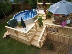 an above ground pool surrounded by decking and patio furniture with umbrellas over it