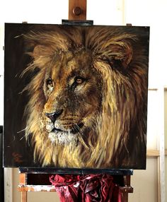 a painting of a lion on an easel