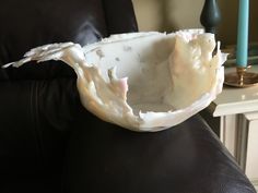 a white bowl sitting on top of a black chair