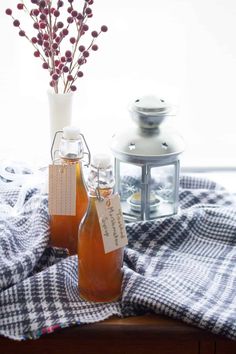 two bottles filled with liquid sitting on top of a table