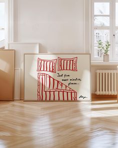 an art piece on the floor in front of a window with a red and white painting