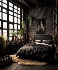 a bedroom with brick walls and lots of plants on the floor, along with a large bed