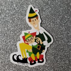 a sticker with an image of a man holding a elf's leg on the floor