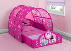 a child's bedroom with pink walls and flooring, including a minnie mouse tent bed