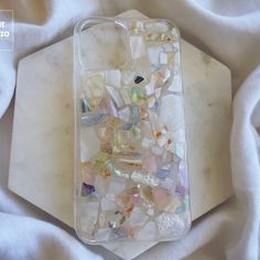 a cell phone case that has been made out of sea glass and other things on it