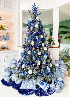 a blue and white christmas tree with ornaments