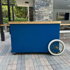 an ice cream cart with wheels on the ground