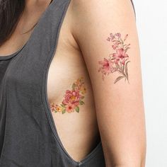 a woman with a flower tattoo on her shoulder