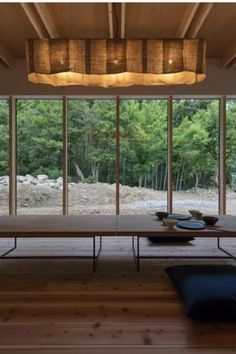 an empty room with wooden floors and large glass doors leading to the outside area that is covered in wood planks