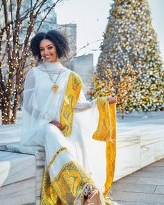 This Habesha dress is made with the finest quality Menen fabric, known for its exceptional softness and durability. The dress is fully handwoven by skilled artisans, using a traditional technique called Shimena, which has been passed down from generation to generation. The Shimena technique involves weaving the fabric by hand, using a loom that is operated manually. This results in a fabric that is unmatched in quality, with a unique texture and feel that cannot be replicated by machines. The dr Ethiopian New Year, Habesha Clothes, Ethiopian Flag, Eritrean Dress, Ethiopian Clothing, Habesha Dress, Ethiopian Traditional Dress, Ethiopian Dress, Habesha Kemis