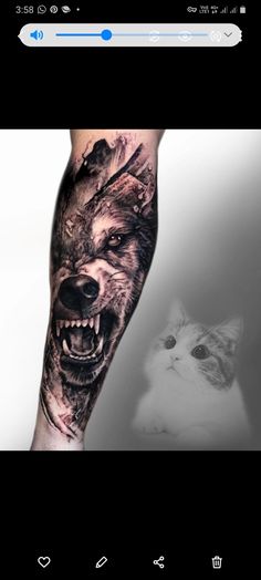 a man's arm with a wolf tattoo on it and a cat in the background