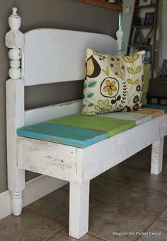 a white bench with a pillow on top of it