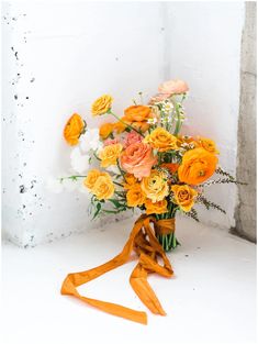 a bouquet of flowers sitting on top of a white table