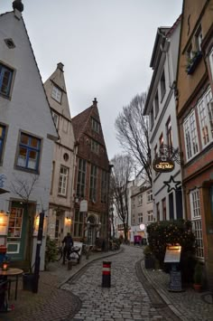 a cobblestone street lined with tall buildings