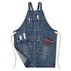 a denim apron with scissors and other tools in the pocket, on a white background