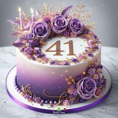 a birthday cake decorated with purple flowers and candles