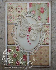 a card with a butterfly on it and flowers in the background, as well as an embellishment