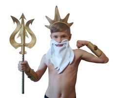 a young boy wearing a crown and holding a staff with two horns on his head