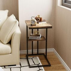 a living room with a couch, table and chair next to a window in the corner