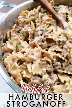 a close up of food in a pan on a table with text overlay that reads helpful hamburger stroganooffi