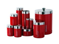 red kitchen canisters with stainless steel lids and silver caps are stacked on top of each other