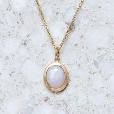 A milky crystal opal has been set into our classic matte gold bezel. Opal measures 10 x 8 mm oval. Weight without chain 2.5g approx. Trace chain measures 45cm. Pictured with a matte finish. For a high shine finish, please leave a note at checkout. Please note, we will match the opal as close to the image as possible. Each opal is unique and may vary in appearance and colour from what is depicted on the site. Yellow Gold Opal Oval Necklace, Oval Opal Necklace In Yellow Gold, Yellow Gold Oval Opal Necklace, Oval Yellow Gold Opal Necklace, White Oval Opal Necklace, 14k Gold Oval White Necklace, 14k Gold Oval Necklace In White, White Oval 14k Gold Necklace, White 14k Gold Oval Necklace