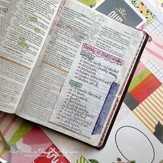 an open bible sitting on top of a table