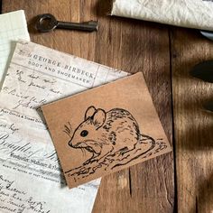 a mouse stamp sitting on top of a piece of paper next to scissors and other items