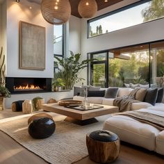 a living room with couches, coffee table and fire place in the center area