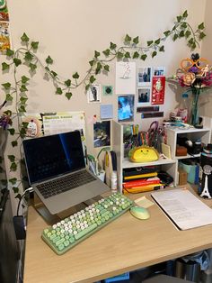 a laptop computer sitting on top of a wooden desk next to a keyboard and mouse