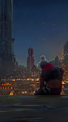 a man sitting on top of a roof looking at the city lights in the distance