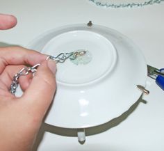 the person is trying to remove the chain from the plate