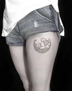 a woman's thigh with a tattoo on it