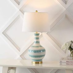 a blue and white striped lamp on a table