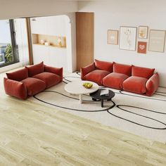 a living room filled with red couches and a white coffee table in front of a large window