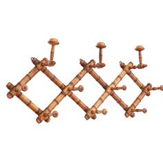 four wooden pegs are arranged in the shape of an x and three other wood pegs