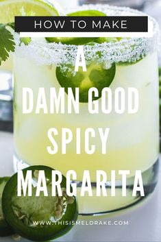 a drink with limes on the rim and text overlay that reads how to make a damn good spicy margarita