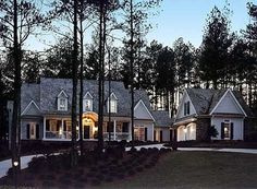 a large house surrounded by trees in the evening