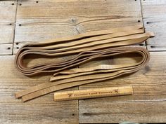 several pieces of wood sitting on top of a wooden floor next to a measuring tape