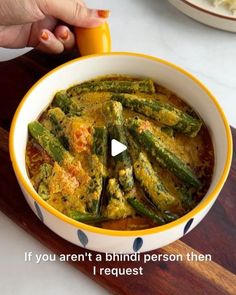 someone is cooking some food in a yellow and white bowl on a wooden board with the words if you aren't a hindu person then i request