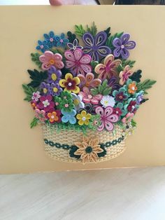 a basket filled with lots of colorful flowers