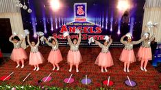 girls in pink dresses are performing on stage